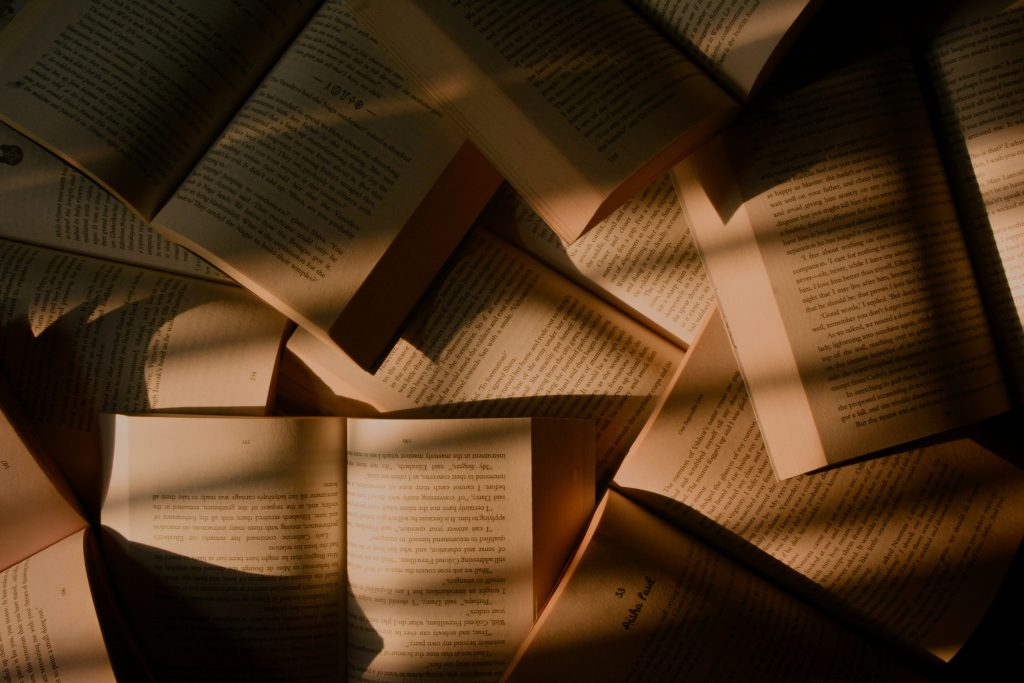 Open books on a pile